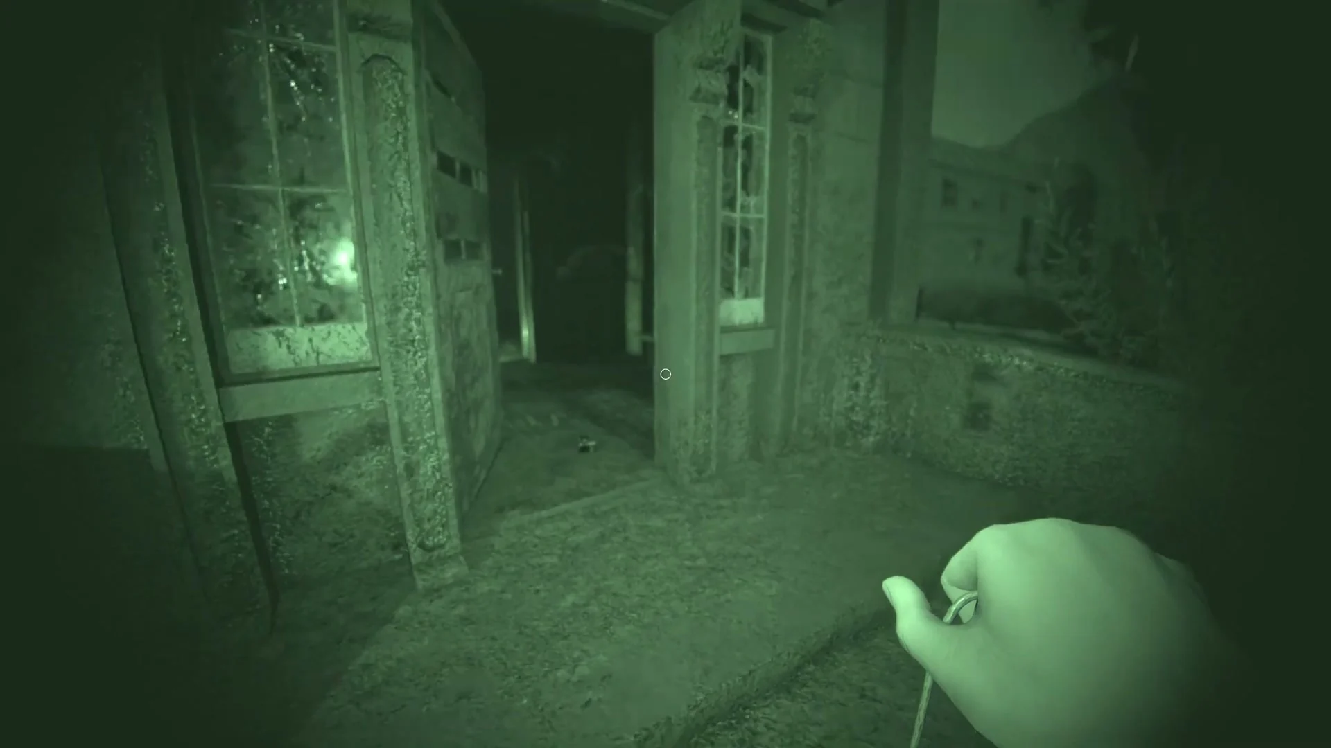 Night vision reveals a doorway and narrow passage inside Sunny Meadows.